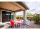 Charming covered patio featuring ample seating area and desert landscaping at 16551 W Winston Dr, Goodyear, AZ 85338