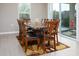 Bright dining room features a marble table, seating for eight and a sliding glass door at 16551 W Winston Dr, Goodyear, AZ 85338