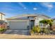 Attractive single-story home with a two-car garage and well-maintained landscaping at 16551 W Winston Dr, Goodyear, AZ 85338
