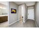 Hallway leading to bathroom and bedroom featuring hard surface floors and neutral paint at 16551 W Winston Dr, Goodyear, AZ 85338