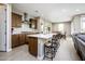 Modern kitchen featuring a large island with seating, stainless steel appliances, and an open-concept layout at 16551 W Winston Dr, Goodyear, AZ 85338
