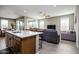 Inviting living area with seamless flow from the kitchen, perfect for modern living and entertaining at 16551 W Winston Dr, Goodyear, AZ 85338