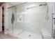 Modern walk-in shower featuring glass door, window and tiled walls with built-in bench at 16551 W Winston Dr, Goodyear, AZ 85338