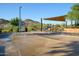 Community splash pad with covered picnic tables and stunning mountain views at 16551 W Winston Dr, Goodyear, AZ 85338
