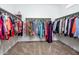 Spacious walk-in closet with hanging racks on both sides, providing ample storage at 16551 W Winston Dr, Goodyear, AZ 85338
