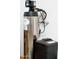 Close-up of a water softener system with a stainless steel tank at 16551 W Winston Dr, Goodyear, AZ 85338