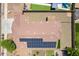 Aerial view of the home showcasing the roof with solar panels and backyard with gravel, artificial turf, and pool at 17531 W Fetlock Trl, Surprise, AZ 85387