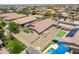 A home with solar panels and artificial turf, set in a neighborhood of similar houses, creating a cohesive aesthetic at 17531 W Fetlock Trl, Surprise, AZ 85387