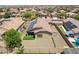 This aerial captures a home with solar panels, a gravel backyard, and an inviting outdoor area at 17531 W Fetlock Trl, Surprise, AZ 85387