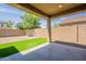 Back patio with partial artificial turf and a view of block wall at 17531 W Fetlock Trl, Surprise, AZ 85387