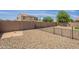 Gravel backyard with fence and a small patch of dirt, ready for your personal touch and landscaping ideas at 17531 W Fetlock Trl, Surprise, AZ 85387