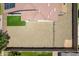 Aerial view of the backyard showcasing gravel area, artificial turf, privacy wall, and neighborhood at 17531 W Fetlock Trl, Surprise, AZ 85387