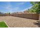 Backyard with low maintenance rock landscaping and a block wall at 17531 W Fetlock Trl, Surprise, AZ 85387