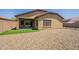 A well-maintained backyard featuring gravel and a small patch of artificial turf, perfect for low-maintenance living at 17531 W Fetlock Trl, Surprise, AZ 85387