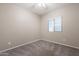 Bright bedroom featuring a window with blinds and neutral carpeting at 17531 W Fetlock Trl, Surprise, AZ 85387
