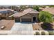 Charming single-story home featuring a three-car garage, low maintenance landscaping, and a concrete driveway at 17531 W Fetlock Trl, Surprise, AZ 85387
