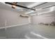 Spacious three car garage with fluorescent lighting and epoxy floor at 17531 W Fetlock Trl, Surprise, AZ 85387