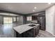 Elegant kitchen with a functional island, stainless steel fridge, and a view to the backyard at 17531 W Fetlock Trl, Surprise, AZ 85387