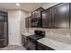 Charming kitchen with dark cabinetry, granite countertops and modern appliances at 17531 W Fetlock Trl, Surprise, AZ 85387