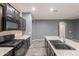 Spacious kitchen layout with stainless steel sink, dark cabinets, and modern appliances at 17531 W Fetlock Trl, Surprise, AZ 85387