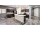 Modern kitchen featuring dark cabinets, an island with light countertops, and stainless steel appliances at 17531 W Fetlock Trl, Surprise, AZ 85387