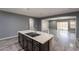 Kitchen island featuring a modern sink and dark wood cabinets, offering seamless flow to the living area at 17531 W Fetlock Trl, Surprise, AZ 85387