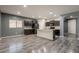 Modern kitchen featuring dark cabinetry, stainless steel appliances, and a center island with counter seating at 17531 W Fetlock Trl, Surprise, AZ 85387