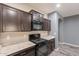 Well-equipped kitchen showcases dark cabinets, a gas range, and stylish countertops at 17531 W Fetlock Trl, Surprise, AZ 85387