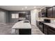 Stylish kitchen features an island with sink, stainless steel appliances, and dark cabinets at 17531 W Fetlock Trl, Surprise, AZ 85387