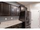 Close-up on the kitchen cabinetry with light countertops and modern stainless steel refrigerator at 17531 W Fetlock Trl, Surprise, AZ 85387