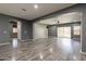 Spacious living room featuring wood floors, neutral paint, recessed lighting, and access to the backyard at 17531 W Fetlock Trl, Surprise, AZ 85387