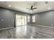 Modern living room with wood floors, recessed lights, and a sliding glass door offering natural light at 17531 W Fetlock Trl, Surprise, AZ 85387