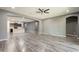 An open-concept living room showcasing wood-style flooring and seamless transition to the connected kitchen area at 17531 W Fetlock Trl, Surprise, AZ 85387