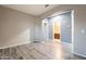 Open-concept living room with elegant archway and wood-look flooring at 17531 W Fetlock Trl, Surprise, AZ 85387