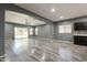 Open concept living area with wood-look tile flooring, a ceiling fan, and sliding glass doors to the backyard at 17531 W Fetlock Trl, Surprise, AZ 85387