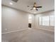 Large main bedroom with carpet, natural light from windows, and an archway leading to the en-suite bathroom at 17531 W Fetlock Trl, Surprise, AZ 85387