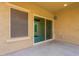 Covered back patio with sliding glass door and block wall at 17531 W Fetlock Trl, Surprise, AZ 85387