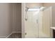Bright bathroom showcasing a frameless glass shower with a hand-held shower wand and modern fixtures at 17531 W Fetlock Trl, Surprise, AZ 85387