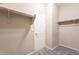 Walk-in closet with installed shelving and access door for easy storage of clothes and accessories at 17531 W Fetlock Trl, Surprise, AZ 85387
