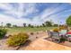 Inviting back patio showcasing the serene golf course views, desert landscaping, and outdoor seating area at 18626 N 130Th Ave, Sun City West, AZ 85375