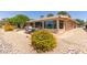 Landscaped backyard featuring desert landscaping, covered patio and colorful flowerbeds, perfect for relaxation and entertaining at 18626 N 130Th Ave, Sun City West, AZ 85375