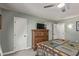 Bedroom featuring a dresser, ceiling fan, carpet, and doors at 18626 N 130Th Ave, Sun City West, AZ 85375