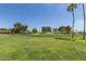 Picturesque golf course view with manicured green, sand traps, and mature trees, creating a tranquil setting at 18626 N 130Th Ave, Sun City West, AZ 85375