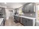 Modern kitchen featuring gray cabinets, quartz countertops, stainless steel appliances, and ample counter space at 18626 N 130Th Ave, Sun City West, AZ 85375