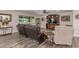 Inviting living room featuring comfortable seating, a ceiling fan, and a large window overlooking the lush backyard at 18626 N 130Th Ave, Sun City West, AZ 85375