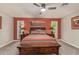 Cozy bedroom featuring a comfortable bed, accent walls, natural light, and warm decor for a relaxing retreat at 18626 N 130Th Ave, Sun City West, AZ 85375