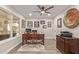 Home office featuring a wooden desk, hardwood floors, a large window and decorative wall art at 18626 N 130Th Ave, Sun City West, AZ 85375