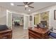 Spacious home office with hardwood flooring, a large desk, views of the living room, and natural light at 18626 N 130Th Ave, Sun City West, AZ 85375