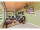 Cozy sunroom with tiled flooring, a wooden ceiling, comfortable seating, and plenty of natural light at 18626 N 130Th Ave, Sun City West, AZ 85375