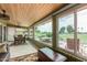 Bright sunroom with wooden ceiling, views of the green golf course, and a comfortable seating area at 18626 N 130Th Ave, Sun City West, AZ 85375